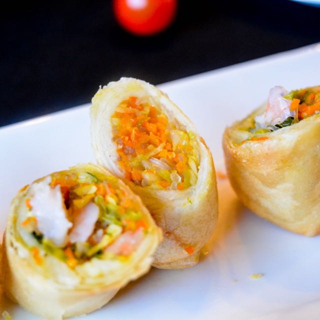Crispy fried spring rolls sliced to show vegetable filling