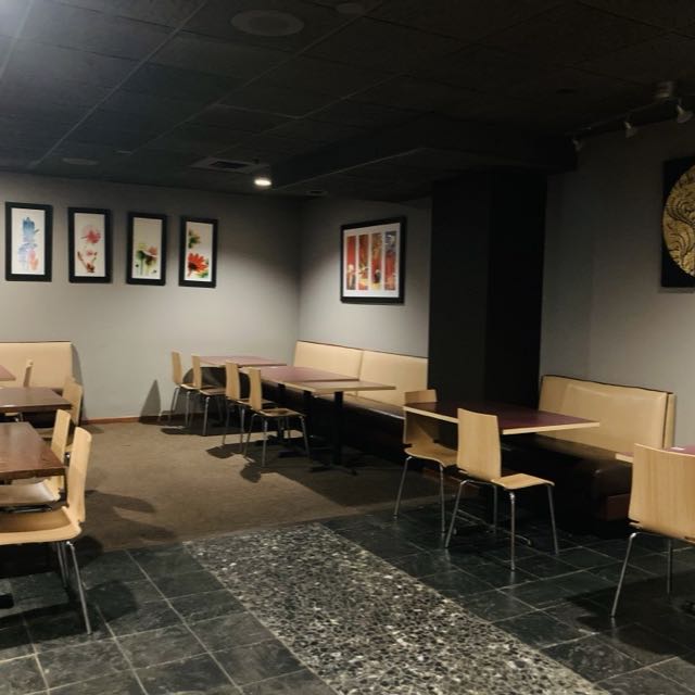 Back dining room at Amarit with booth seating and Thai wall art