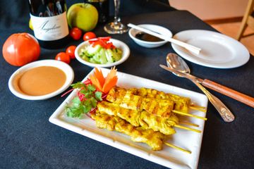 Grilled chicken satay skewers with peanut sauce and cucumber relish