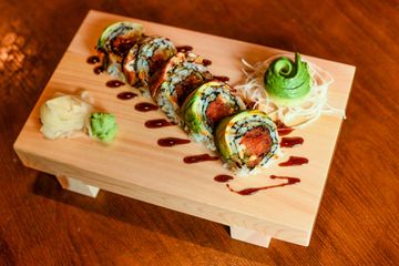 Fire Dragon roll on a wooden sushi board with eel sauce
