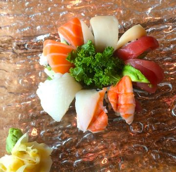 Rainbow roll topped with salmon, tuna, white fish and avocado