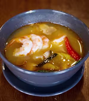 Tom yum soup with shrimp, chili and lemongrass in a blue bowl